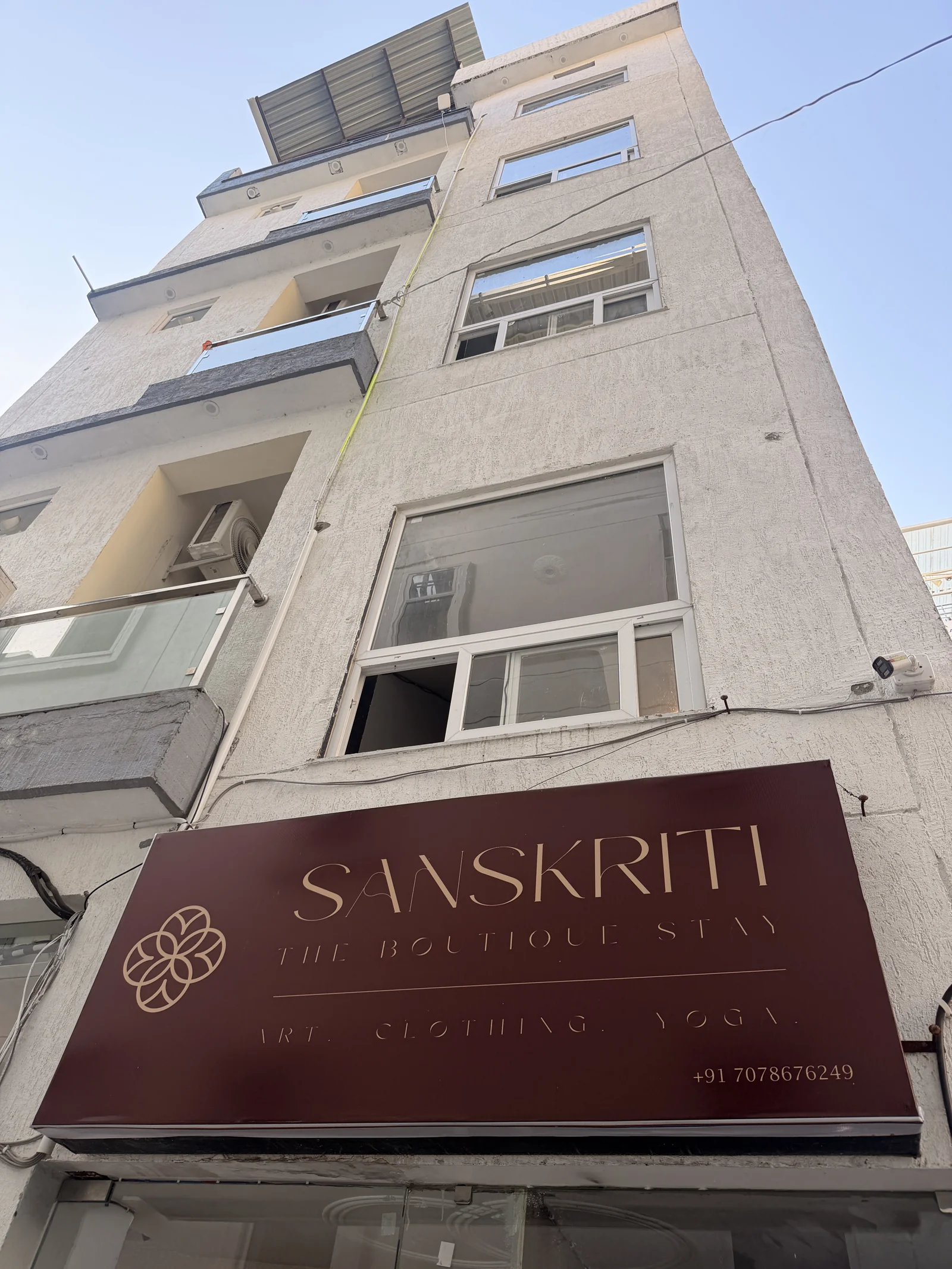 Sanskriti guesthouse exterior and burgundy entrance sign
