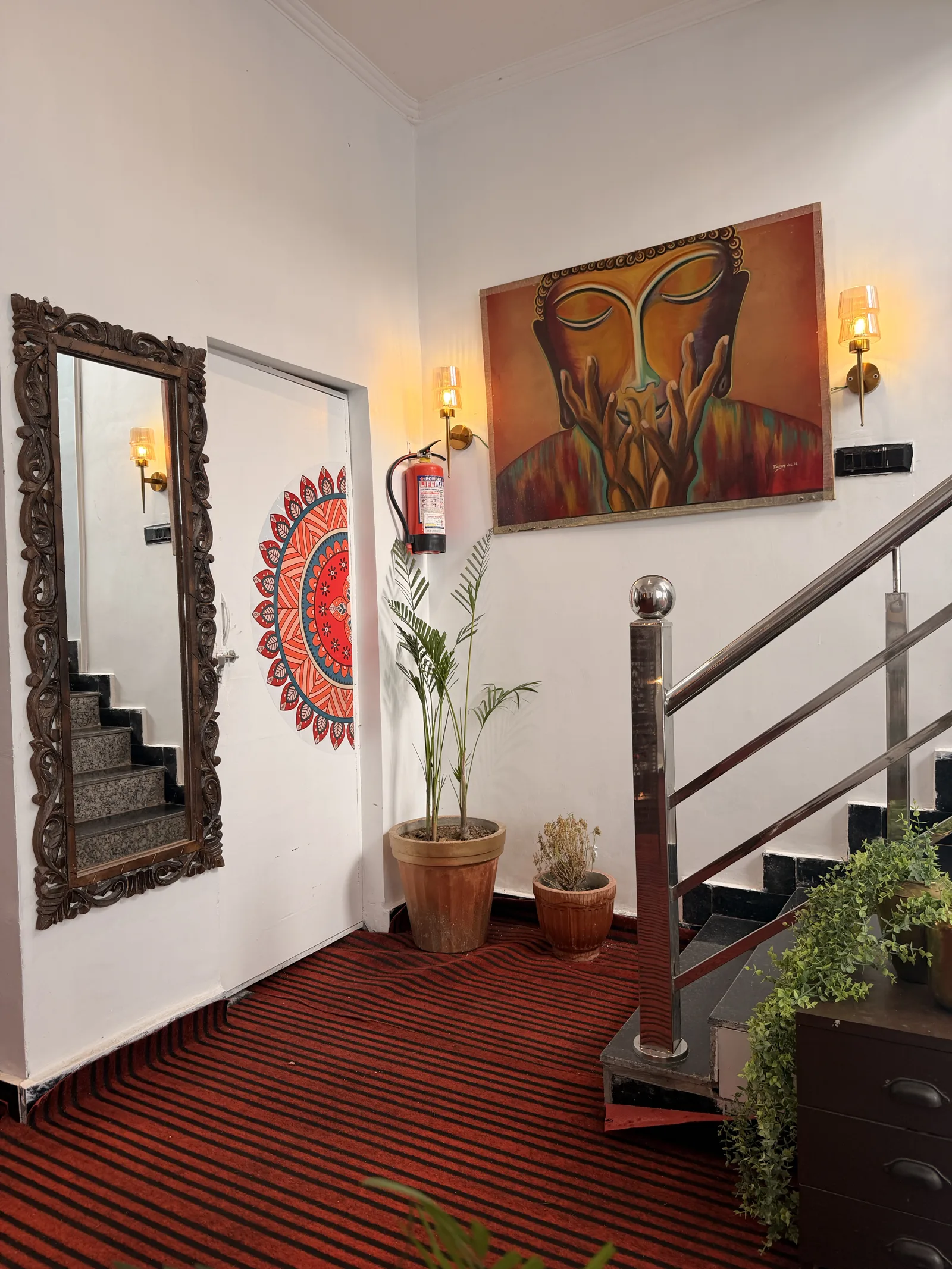 Artwork and plants beside the staircase