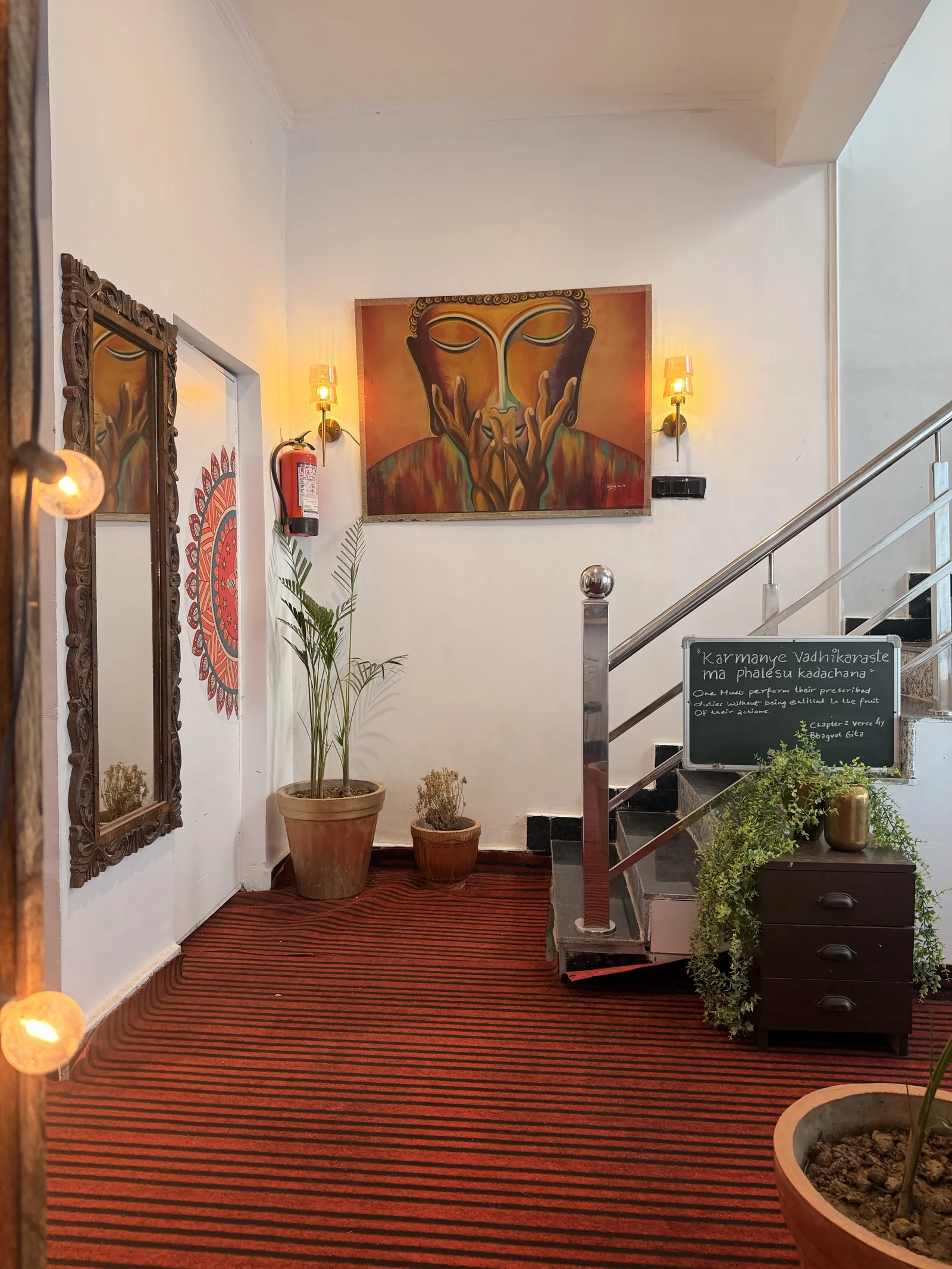 The art-lined staircase and plants inside Sanskriti